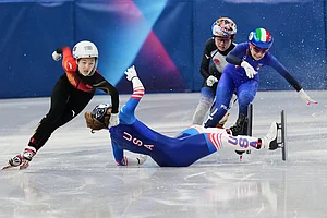 | Photo: AP/Francisco Seco : Corinne Stoddard of the United States wipes out as Xinran Wang of the People's Republic of China moves past to win while competing in the women's 500 meter short track speed skating at the 2026 Winter Olympics, in Milan, Italy.