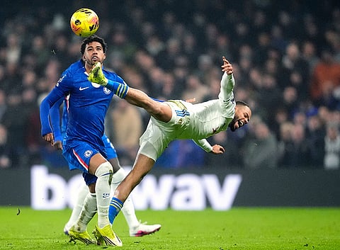 Chelsea's Andrey Santos, left, and Leeds United's Lukas Nmecha battle for the ball battle for the ball during their English Premier League soccer match in London.