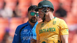 | Photo: AP/Ajit Solanki : Afghanistan's captain Rashid Khan, left shares a light moment with South Africa's David Miller during the T20 World Cup cricket match between Afghanistan and South Africa in Ahmedabad.