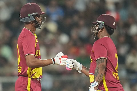 West Indies' Roston Chase, left, Shimron Hetmye encourage each other as they bat during the T20 World Cup cricket match between England and West Indies in Mumbai, India.