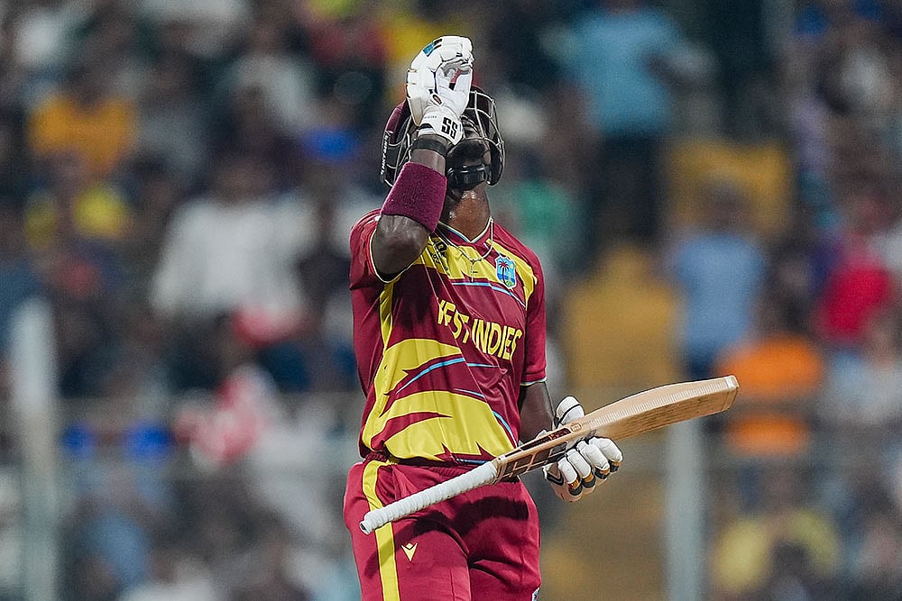 West Indies Sherfane Rutherford celebrates his half century