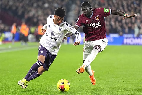 Manchester United's Amad Diallo, left, and West Ham United's El Hadji Malick Diouf battle for the ball during a Premier League soccer match in London. 