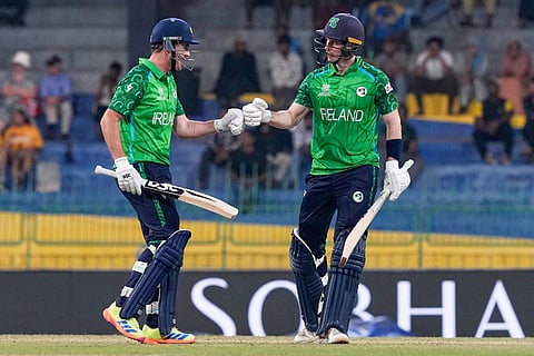 Ireland's Mark Adair, left, and batting partner George Dockrell touch gloves during the T20 World Cup cricket match between Australia and Ireland in Colombo, Sri Lanka.