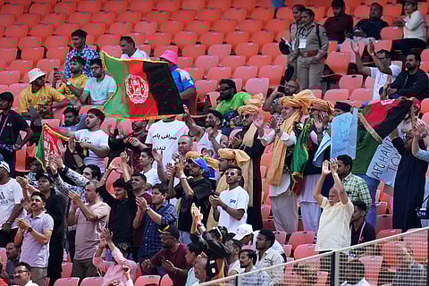 Afghanistan team supporters cheer for their team during the T20 World Cup cricket match between Afghanistan and South Africa in Ahmedabad.