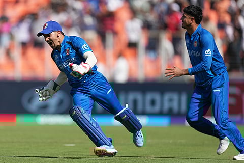 Afghanistan's Rahmanullah Gurbaz celebrate a successful catch to dismiss /South Africa's Dewald Brevis at the super over during the T20 World Cup cricket match between Afghanistan and South Africa in Ahmedabad.