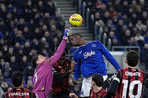 Everton's Thierno Barry, top, attempts to head the ball during their English Premier League soccer match against Bournemouth in Liverpool, England.