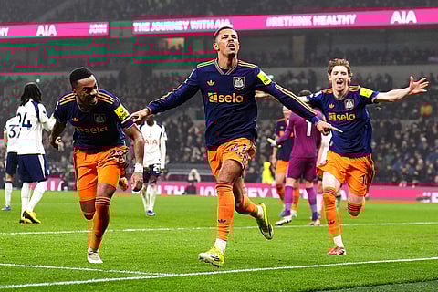 Newcastle United's Jacob Ramsey, center, celebrates scoring their side's second goal against Tottenham during a Premier League soccer match London. 