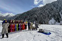 Day In Pics: February 11, 2026 | Photo: PTI : Vendors put up a clothing stall during the 'Snow Festival' at Aru Valley, in Anantnag, Jammu and Kashmir.