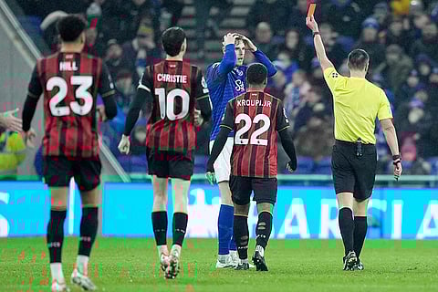Everton's Jake O'Brien reacts after being sent off during a English Premier League soccer match against Bournemouth in Liverpool, England.