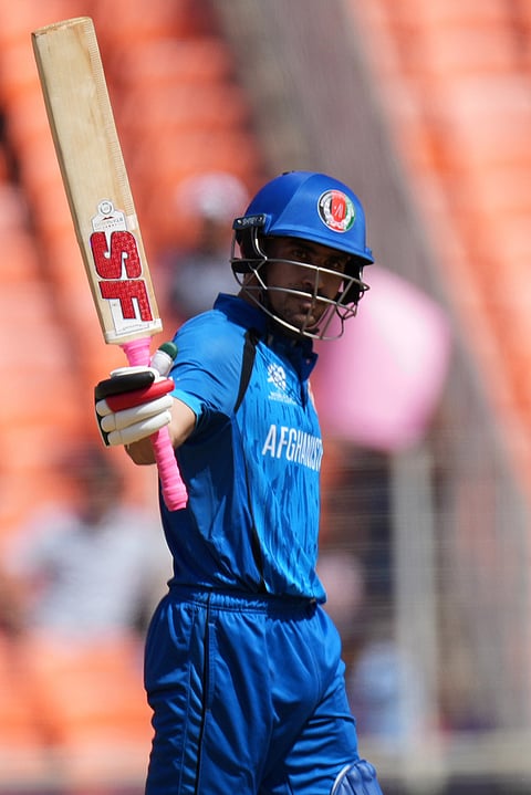 Afghanistan's Rahmanullah Gurbaz celebrates after scoring fifty runs during the T20 World Cup cricket match between Afghanistan and South Africa in Ahmedabad.