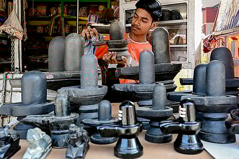 A vendor displays 'shivlings' along with ceremonial objects in a shop ahead of the 'Mahashivratri' festival, in Nadia, West Bengal.