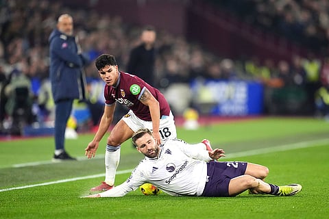 Manchester United's Luke Shaw, front, and West Ham United's Mateus Fernandes battle for the ball during a Premier League soccer match in London.
