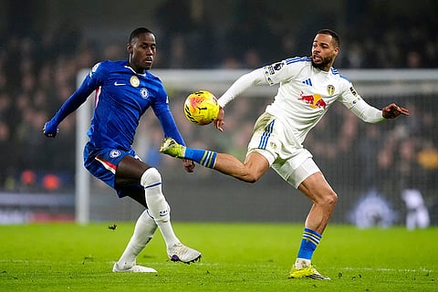 Chelsea's Trevoh Chalobah, left, and Leeds United's Lukas Nmecha battle for the ball battle for the ball during their English Premier League soccer match in London.