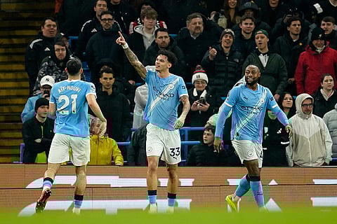 Manchester City's Nico O'Reilly, center, celebrates with teammates after scoring his side's second goal during the English Premier League soccer match between Manchester City and Fulham in Manchester, England.