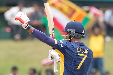 Sri Lanka's captain Dasun Shanaka celebrates his fifty runs during the T20 World Cup cricket match between Oman and Sri Lanka in Pallekele, Sri Lanka.