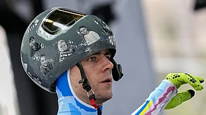 (AP Photo/Alessandra Tarantino) : Ukraine's Vladyslav Heraskevych arrives at the finish during a men's skeleton training session at the 2026 Winter Olympics, in Cortina d'Ampezzo, Italy, Tuesday, Feb. 10, 2026.