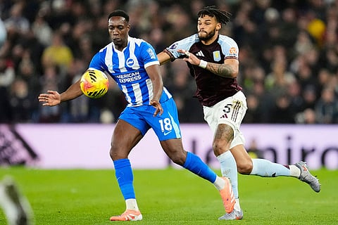 Brighton's Danny Welbeck, left, and Aston Villa's Tyrone Mings battle for the ball during their English Premier League soccer match in Birmingham, England.