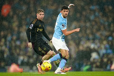 Fulham's Emile Smith Rowe, left, and Manchester City's Matheus Nunes challenge for the ball during the English Premier League soccer match between Manchester City and Fulham in Manchester, England.