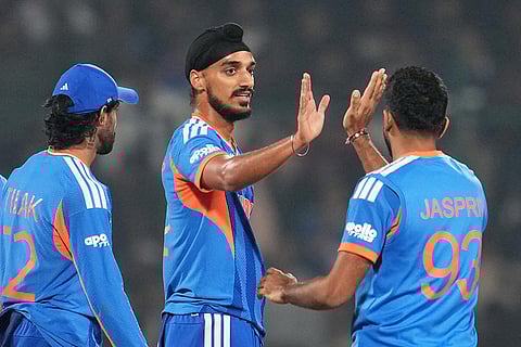 India's Arshdeep Singh, center, celebrates with teammate Jasprit Bumrah the wicket of Namibia's Jan Frylinck during the T20 World Cup cricket match between India and Namibia in New Delhi.