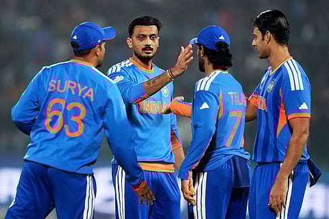 India's Axar Patel, facing the camera, celebrates with teammates the wicket of Namibia's captain Gerhard Erasmus during the T20 World Cup cricket match between India and Namibia in New Delhi.