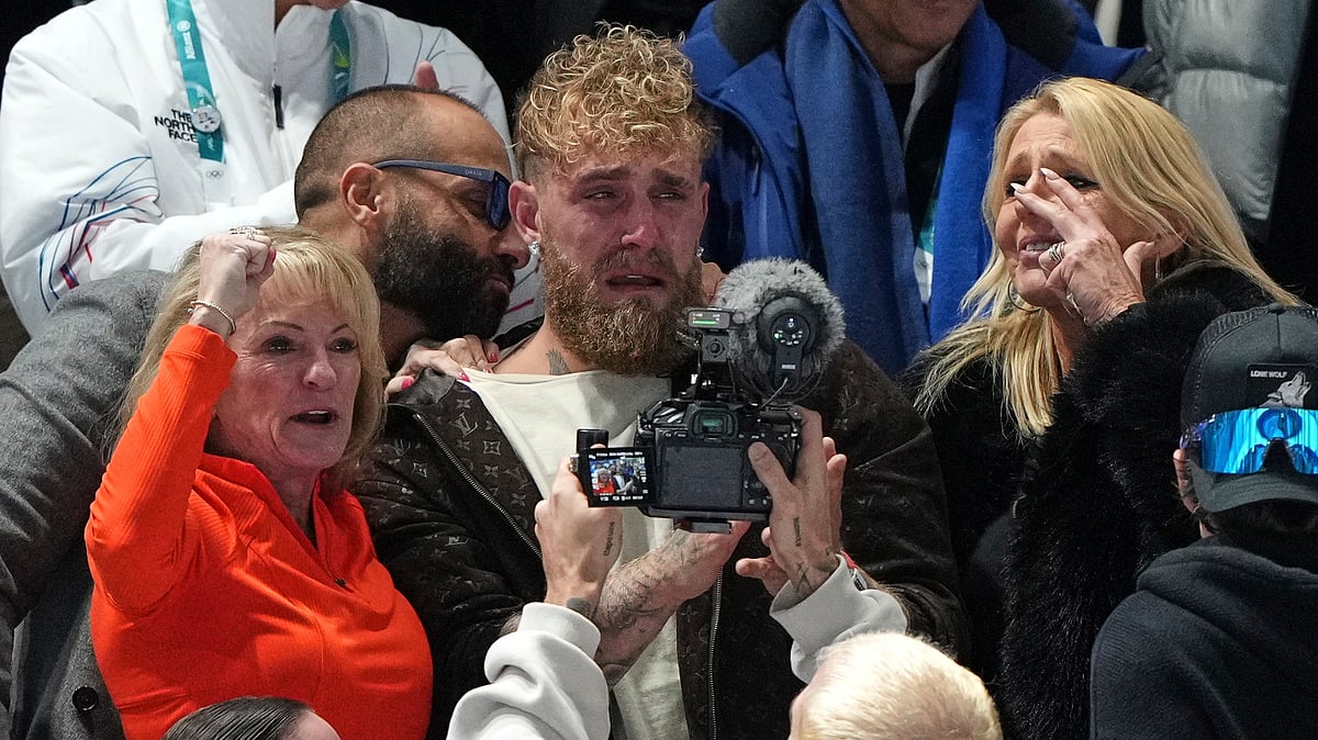 Jake Paul of the U.S., center, cries after his fiancé Jutta Leerdam of the Netherlands won the gold medal in the women's 1,000 meters speedskating race at the 2026 Winter Olympics, in Milan, Italy, Monday, Feb. 9, 2026.  - (AP Photo/Antonio Calanni)