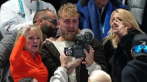 (AP Photo/Antonio Calanni) : Jake Paul of the U.S., center, cries after his fiancé Jutta Leerdam of the Netherlands won the gold medal in the women's 1,000 meters speedskating race at the 2026 Winter Olympics, in Milan, Italy, Monday, Feb. 9, 2026.