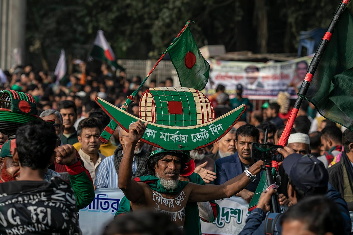 A supporter of Bangladesh's ruling Awami League party is seen carrying the party's election symbol boat on his head as he arrives at Suhrawardy Udyan to attend a public rally. The Awami League leaders and activists gathered at Suhrawardy Udyan to attend a public rally organized to commemorate the historic homecoming day of the Father of the Nation, Bangabandhu Sheikh Mujibur Rahman. - IMAGO / ZUMA Press Wire