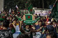 IMAGO / ZUMA Press Wire : A supporter of Bangladesh's ruling Awami League party is seen carrying the party's election symbol boat on his head as he arrives at Suhrawardy Udyan to attend a public rally. The Awami League leaders and activists gathered at Suhrawardy Udyan to attend a public rally organized to commemorate the historic homecoming day of the Father of the Nation, Bangabandhu Sheikh Mujibur Rahman.