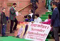 Ravi Choudhary : Union Minister of Parliamentary Affairs Kiren Rijiju, second left, arrives as suspended Lok Sabha MPs Prashant Padole, third right, Dean Kuriakose, centre, and other opposition MPs stage a protest during the Budget session of Parliament, in New Delhi. 