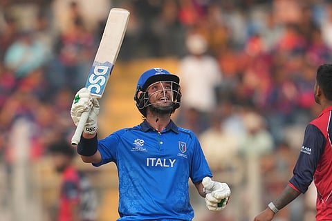 Italy's Justin Mosca celebrates his fifty runs during the T20 World Cup cricket match between Italy and Nepal in Mumbai, India.