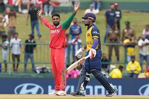 Oman's Jiten Ramanandi celebrates the wicket of Sri Lanka's captain Dasun Shanaka during the T20 World Cup cricket match between Oman and Sri Lanka in Pallekele, Sri Lanka.