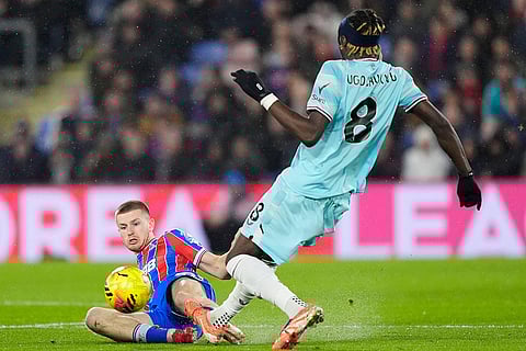 Crystal Palace's Adam Wharton, left, and Burnley's Lesley Ugochukwu battle for the ball during their English Premier League soccer match in London.
