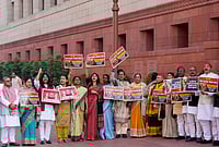  PTI : Samajwadi Party (SP) MP Priya Saroj, centre, Congress MP Praniti Shinde, fourth left, and others stage a protest over the India-US interim trade deal, during the Budget session of Parliament, in New Delhi, Thursday, Feb. 12, 2026. 