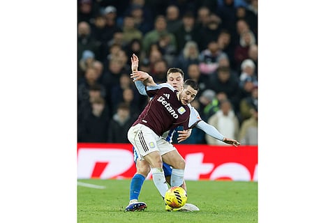 Aston Villa's Emi Buendia and Brighton's Joel Veltman battle for the ball during their English Premier League soccer match in Birmingham, England.