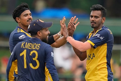 Sri Lanka's Dushmantha Chameera, right, celebrates with teammates the wicket of Oman's Hammad Mirza during the T20 World Cup cricket match between Oman and Sri Lanka in Pallekele, Sri Lanka.