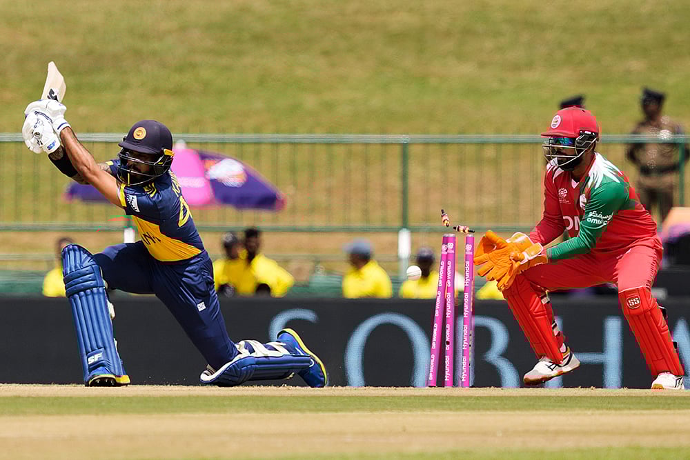 Sri Lanka's Kamil Mishara bowled out by Oman's Jay Odedra during the T20 World Cup cricket match between Oman and Sri Lanka in Pallekele, Sri Lanka. - | Photo: AP/Eranga Jayawardena