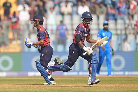 Nepal's Aasif Sheikh and Nepal's captain Rohit Paudel run between the wickets as they bat during the T20 World Cup cricket match between Italy and Nepal in Mumbai, India.
