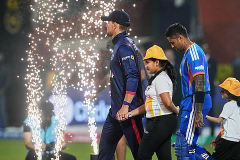 Namibia's captain Gerhard Erasmus, left, and India's captain Suryakumar Yadav step out on to the field before the start of the T20 World Cup cricket match between India and Namibia in New Delhi.