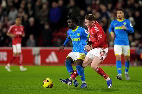 Wolverhampton Wanderers' Mateus Mane, left, battles for the ball with Nottingham Forest's Elliot Anderson during their English Premier League soccer match in Nottingham, England.