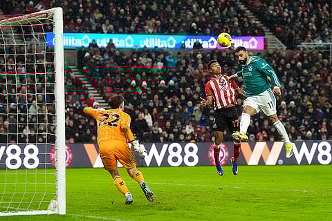Liverpool's Mohamed Salah, right, heads at goal during their English Premier League soccer match against Sunderland in Sunderland, England.
