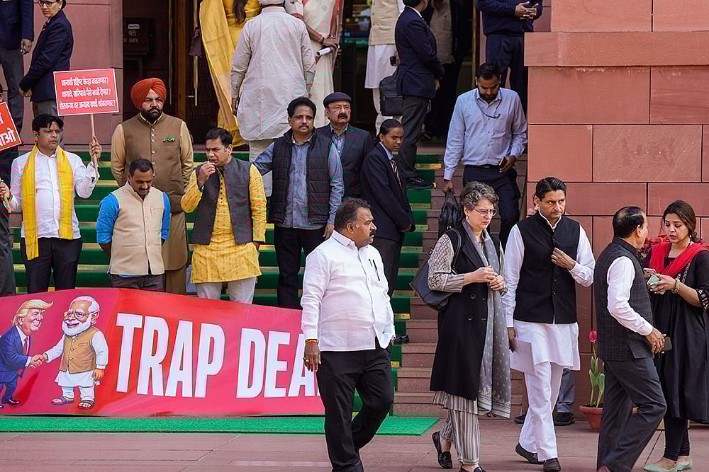Congress MP Priyanka Gandhi Vadra, suspended MPs Hibi Eden, Dean Kuriakose, Prashant Padole, Manickam Tagore and other opposition MPs stage a protest over the India-US interim trade deal, accusing the government of "surrendering" Indian interests, during the Budget session of Parliament, in New Delhi. - | Photo: PTI/Salman Ali