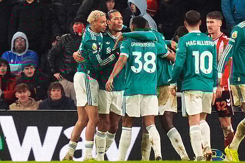 Liverpool's Virgil van Dijk, second left, celebrates scoring their side's first goal of the game during the English Premier League soccer match against Sunderland, in Sunderland, England.