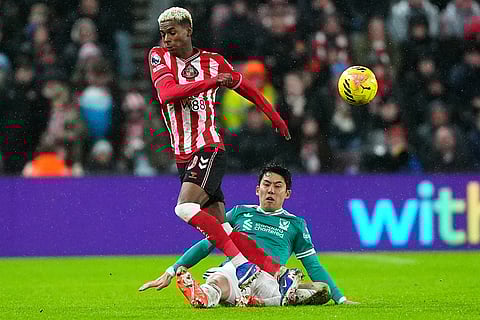 Sunderland's Nilson Angulo, left, and Liverpool's Wataru Endo battle for the ball during the English Premier League soccer match, in Sunderland, England.