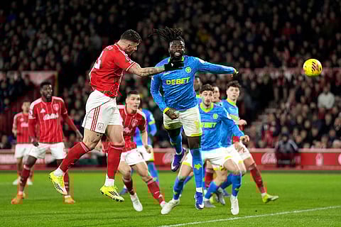 Nottingham Forest's Morato, top left, has a shot on goal during the English Premier League soccer match between Nottingham Forest and Wolverhampton Wanderers, in Nottingham, England.