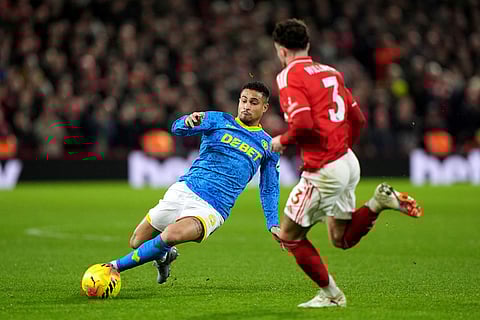 Wolverhampton Wanderers' Joao Gomes, left, battles for the ball with Nottingham Forest's Neco Williams during their English Premier League soccer match in Nottingham, England.