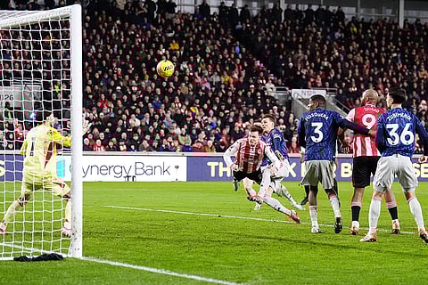 Brentford's Keane Lewis-Potter, center, scores their side's first goal  during the English Premier League soccer match between Brentford and Arsenal in London.