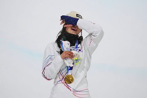 Gold medalist South Korea's Choi Ga-on reacts on the podium after winning the women's snowboarding halfpipe finals at the 2026 Winter Olympics, in Livigno, Italy.