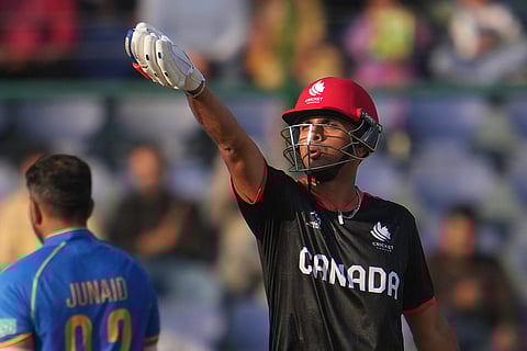 Canada's Harsh Thaker celebrates his fifty runsduring the T20 World Cup cricket match between Canada and United Arab Emirates in New Delhi.