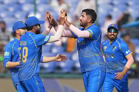 United Arab Emirates' Junaid Siddique, second right, celebrates the wicket of United Arab Emirates' Junaid Siddique during the T20 World Cup cricket match between Canada and United Arab Emirates in New Delhi.