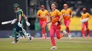 (AP Photo/Eranga Jayawardena) : Zimbabwe's Bradley Evans, center, celebrates the wicket of Australia's Ben Dwarshuis during the T20 World Cup cricket match between Australia and Zimbabwe in Colombo, Sri Lanka, Friday, Feb. 13, 2026
